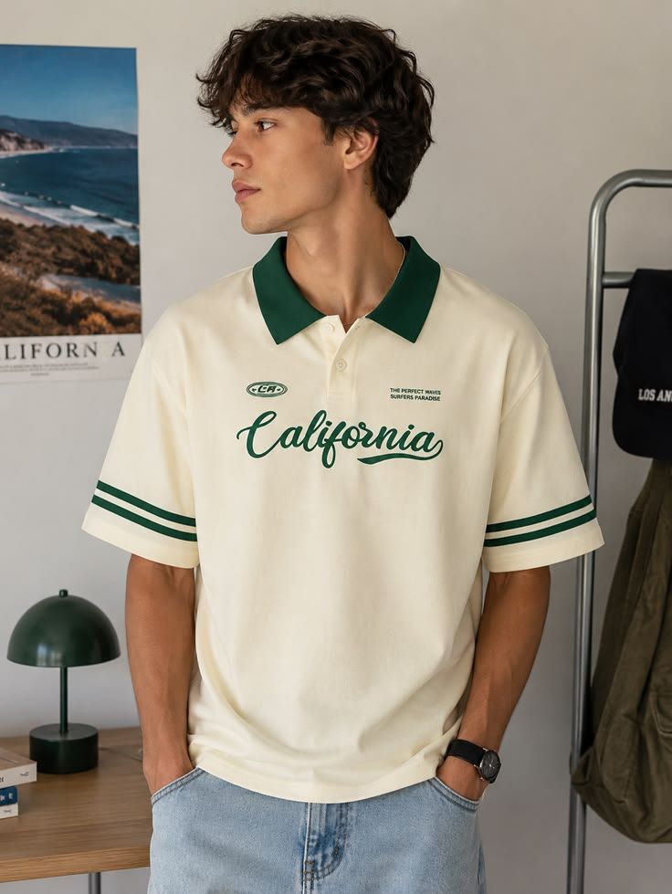 Men's cream polo T-shirt with a green collar, double-striped sleeves, and "California" script print on the front, featuring a relaxed fit for casual everyday wear.