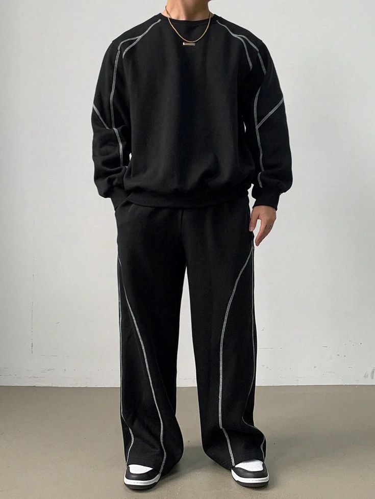Men's black oversized co-ord tracksuit featuring a relaxed-fit crewneck sweatshirt with contrast stitch detailing and matching wide-leg sweatpants for a modern streetwear look.