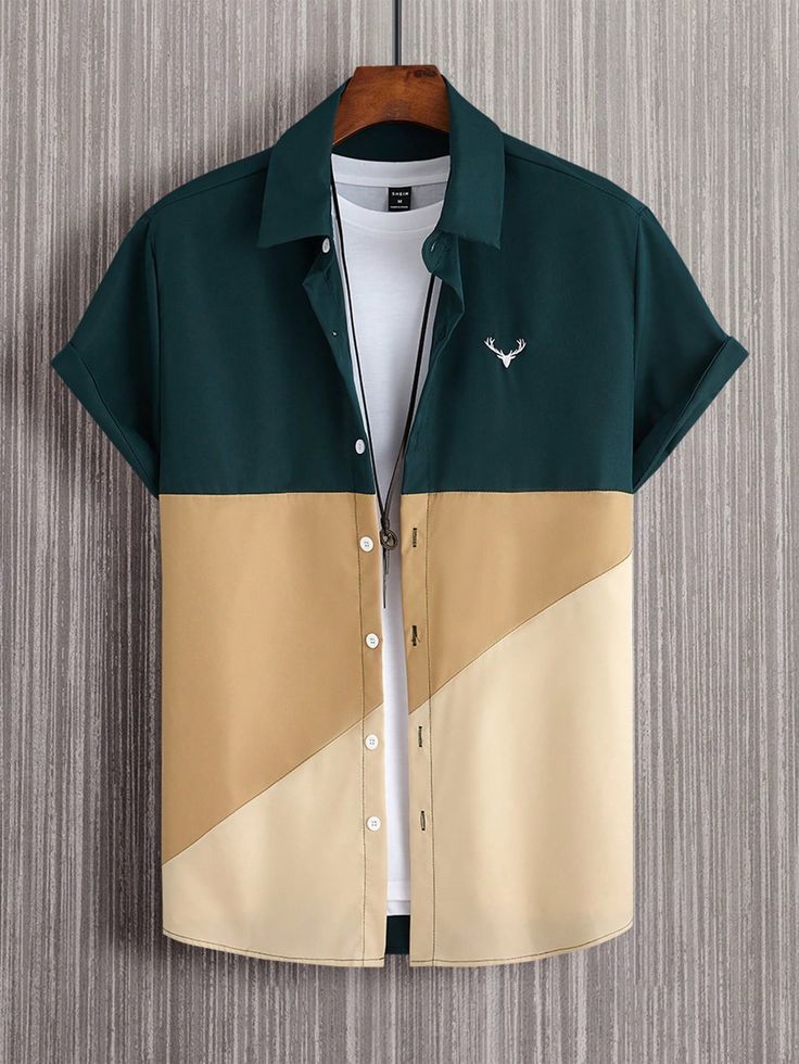 Dark green, beige, and cream color-block short-sleeve button-up shirt with a camp collar, rolled sleeves, and a small embroidered deer logo on the chest.