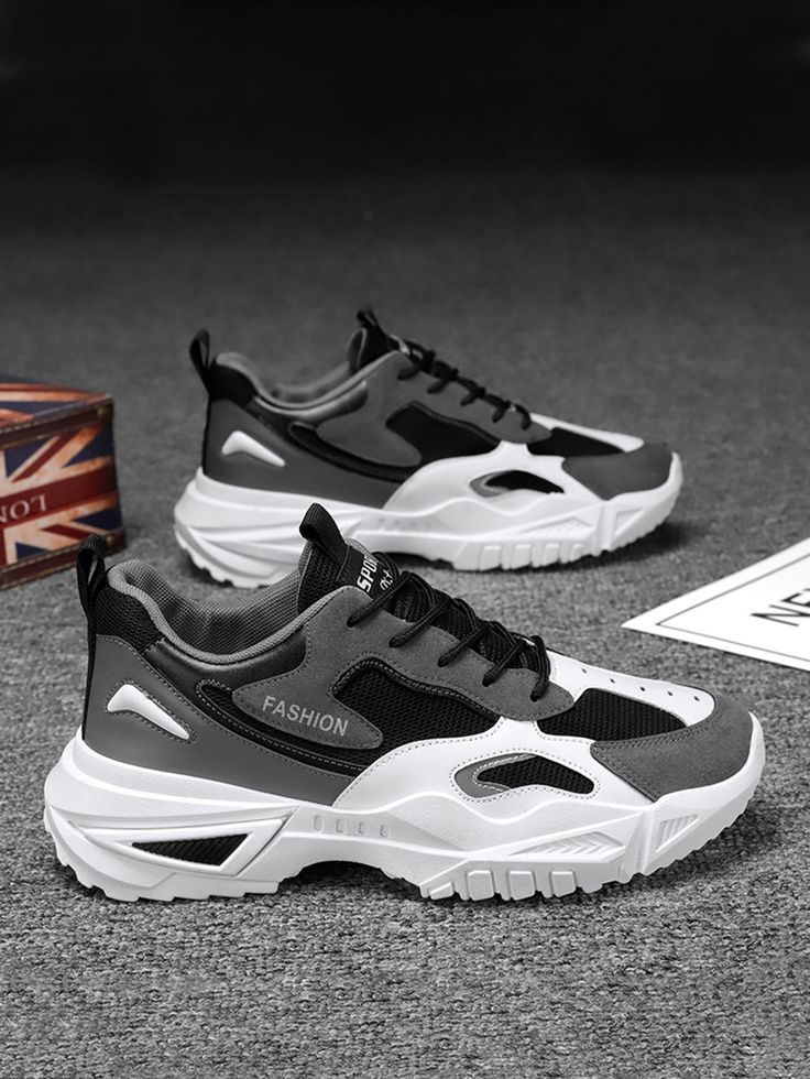 Black, grey, and white men's athletic sneakers featuring a breathable mesh upper, lace-up closure, cushioned sole, and durable chunky outsole for everyday comfort.