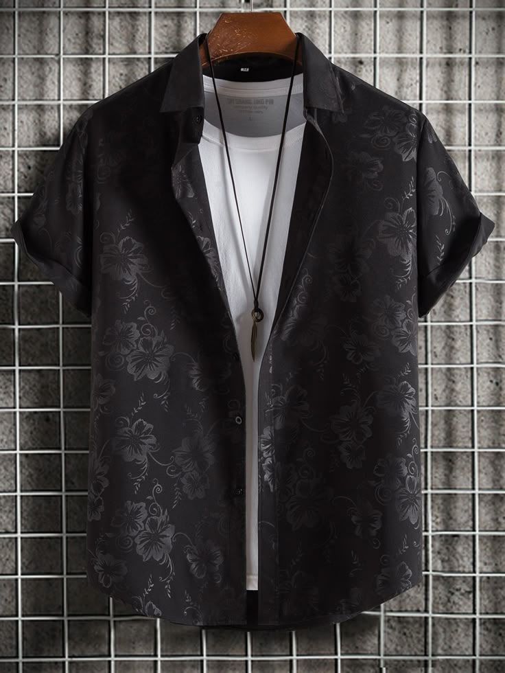 Black short-sleeve button-up shirt with a subtle floral jacquard pattern, camp collar, and relaxed fit, layered over a white T-shirt for a modern casual look.