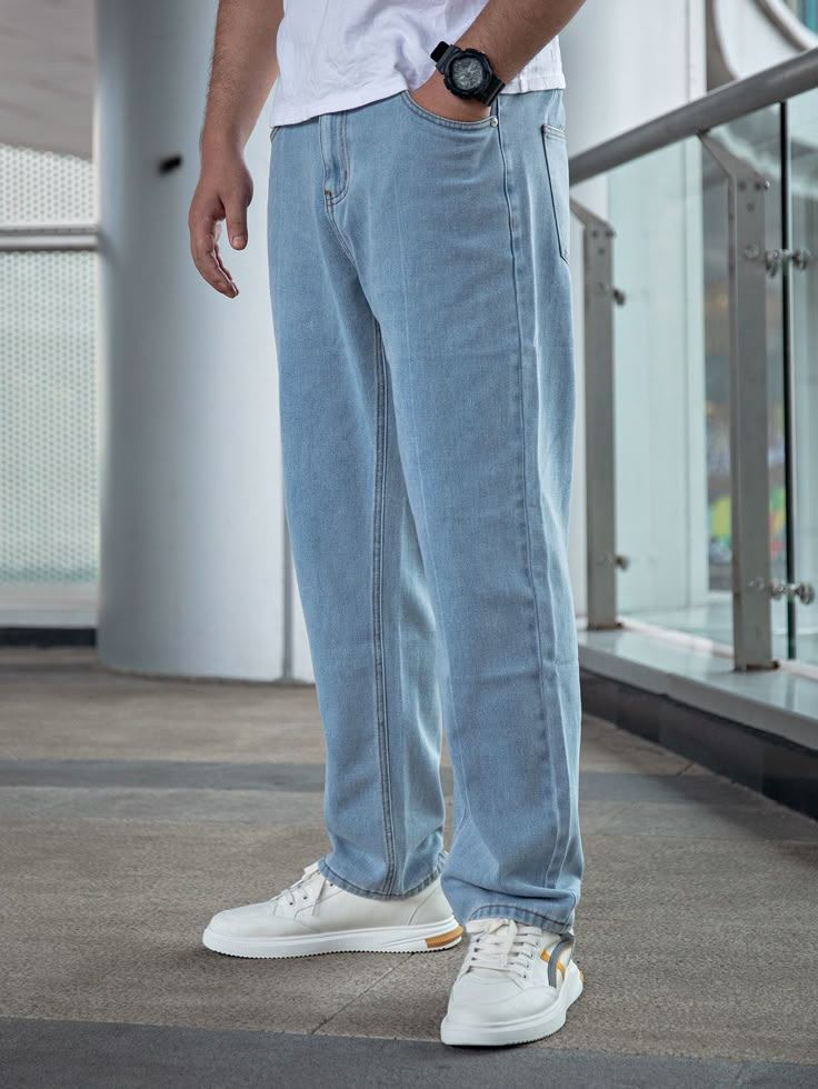 Light blue relaxed-fit denim jeans with a straight-leg silhouette, paired with white sneakers for a casual everyday look.